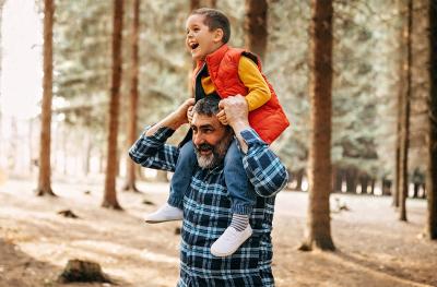 Photo of Grandpa holding grandson on his shoulders