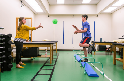 Physical therapist Mackenzie Gerau works with a patient who is recovering from a concussion.