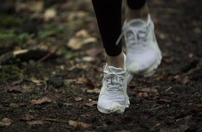 running shoes of a jogger on a trail
