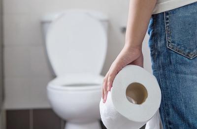 person at toilet with toilet paper