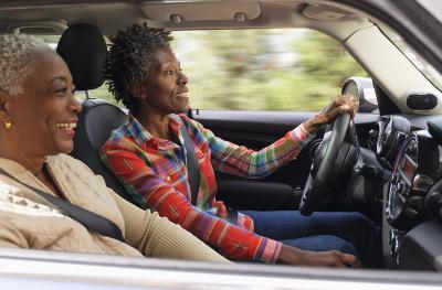 two smiling women in a car