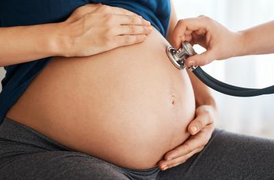 pregnant woman with a stethoscope on her belly