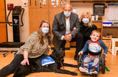 Gary Pinkel and his wife, Missy, with Blaze a Children’s Therapy Center facility dog and Brody Moreland, a therapy patient.