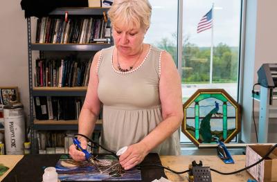 Teresa Woody, a retired veteran of the Air Force and Navy, enjoys making stained glass art work in her spare time.