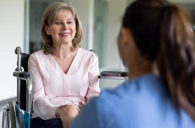 woman in a wheelchair talking to a doctor