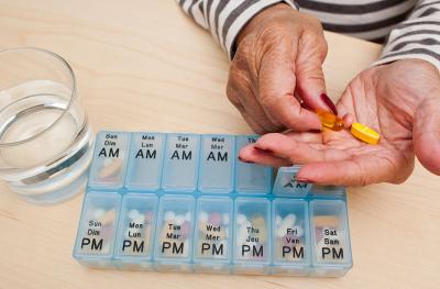 woman sorting medication pills