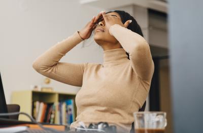 Stressed woman with her hands on her head
