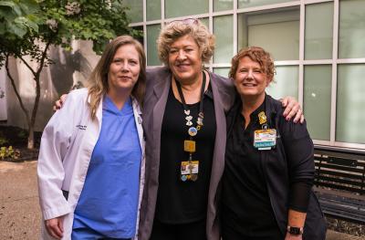 (From left) Kim Pfeiffer, Donna Pond, and Daphne Ingebritson stand in the Healing Garden.