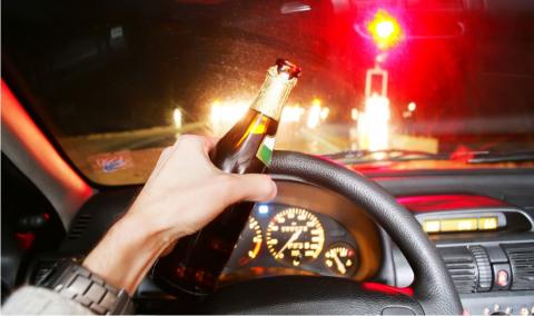 Drinking beer while driving car.