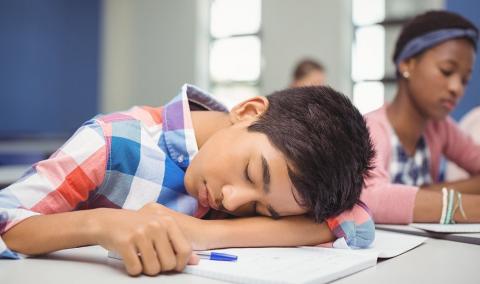 boy sleeping in school