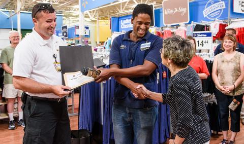 Joanne Witting, right, expresses her appreciation during a Community Hero recognition ceremony in June at the West Broadway Walmart in Columbia. 