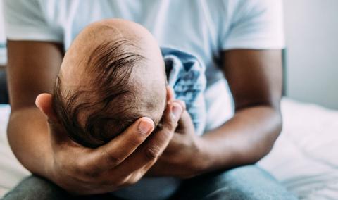 man holding an infant