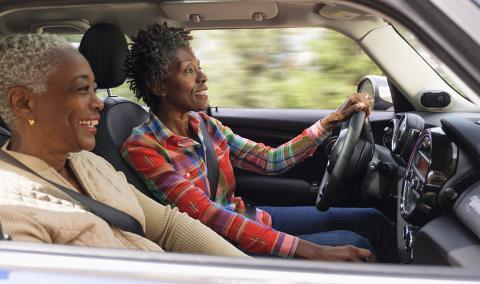 two smiling women in a car