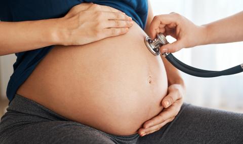 pregnant woman with a stethoscope on her belly