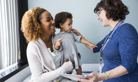 Parent and young child talking to a doctor
