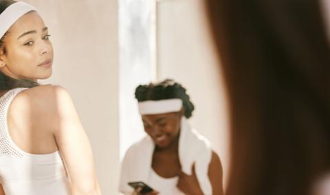 A woman look at herself in the mirror.