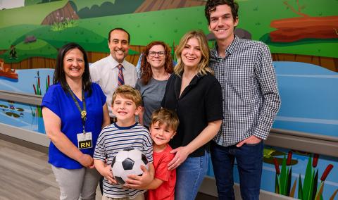 A family and healthcare professionals posing for a photo.