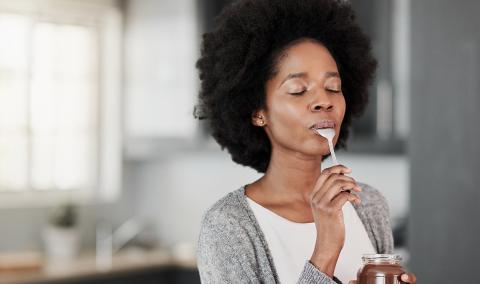 A photo of a woman eating some food.