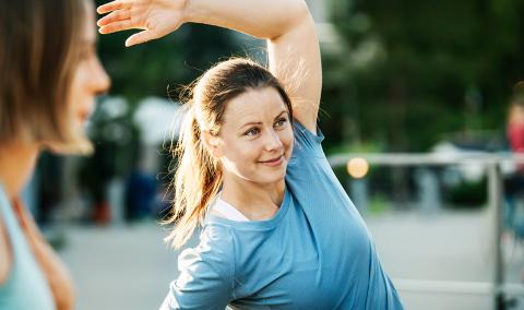 a woman stretching outdooors