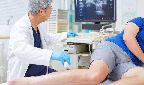 A physician using a machine to examine a patient.