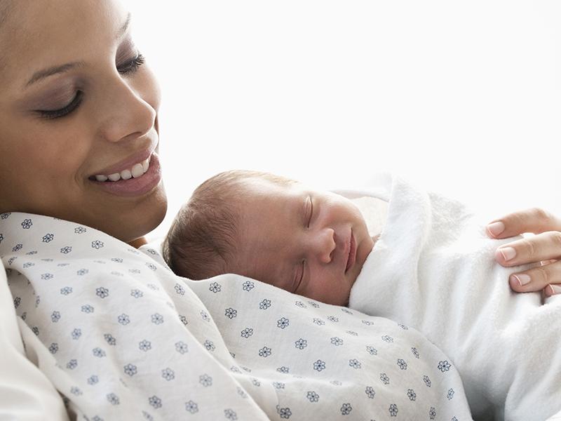 Photo of new mom holding baby on her chest