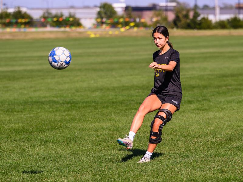 A photo of a girl playing soccer.