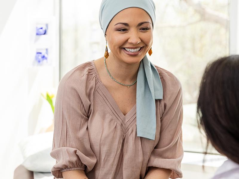 Female cancer patient talking to doctor