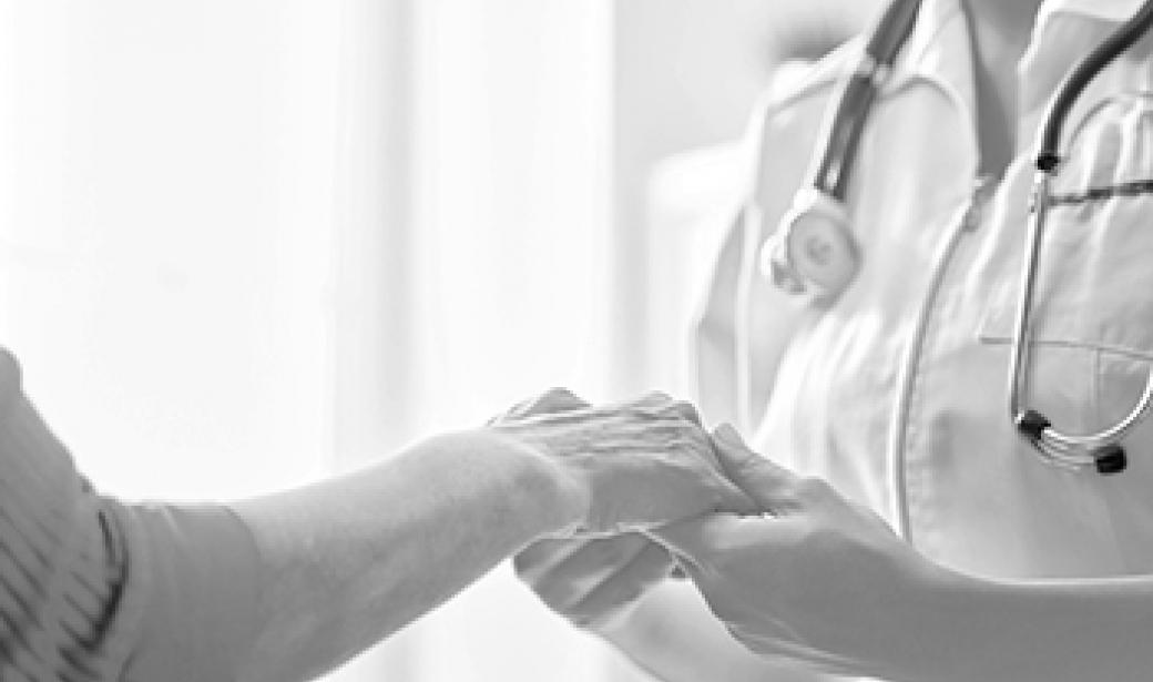 Nurse holding woman's hand