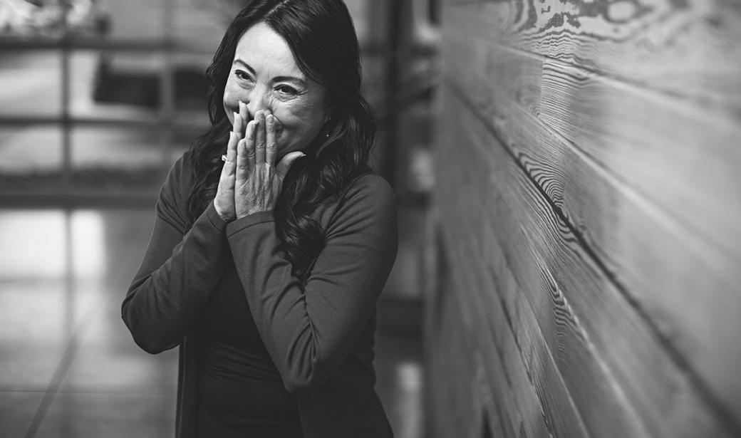 Woman smiling covering her mouth