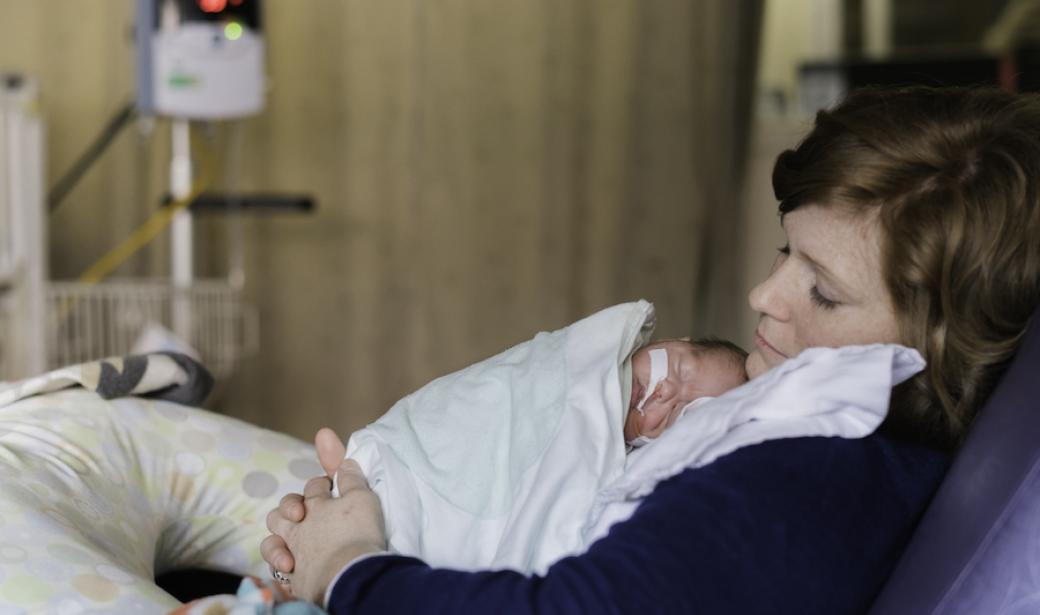 Mother holding baby on her chest