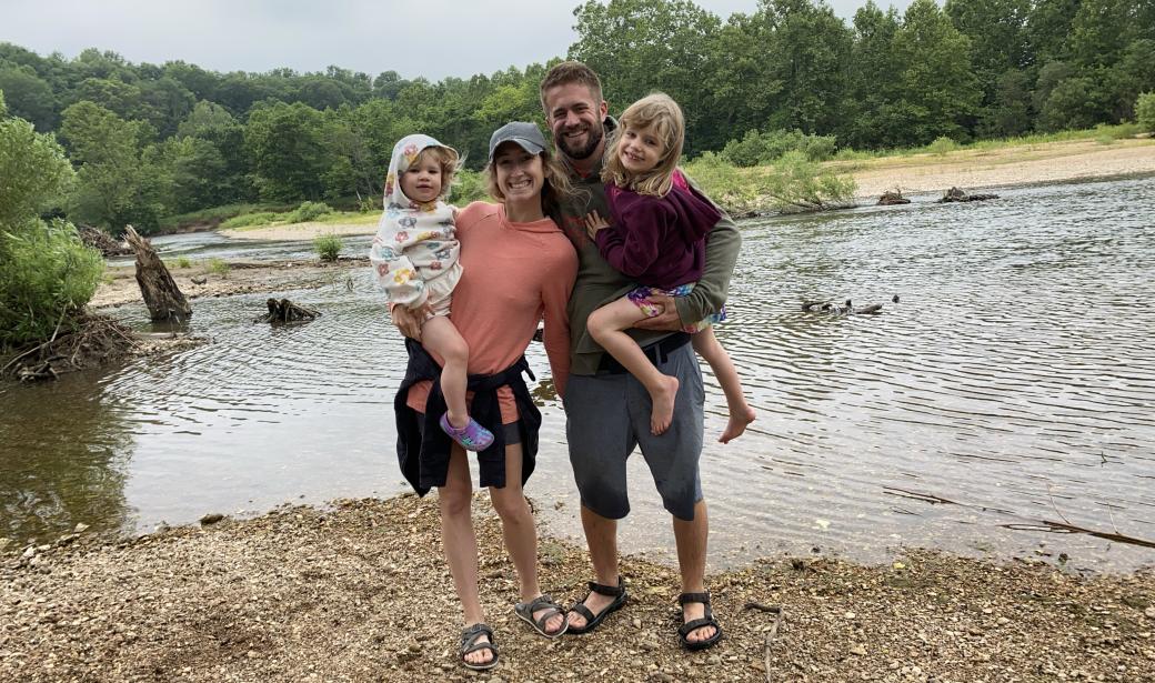 A picture of a family at a lake.