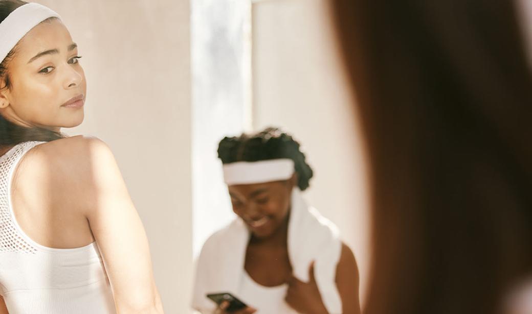 A woman look at herself in the mirror.