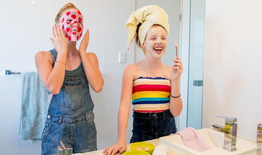 Two teens putting on skincare product