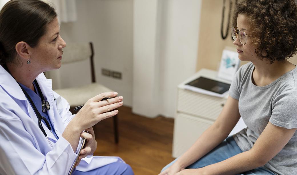 A physician speaking with a woman.