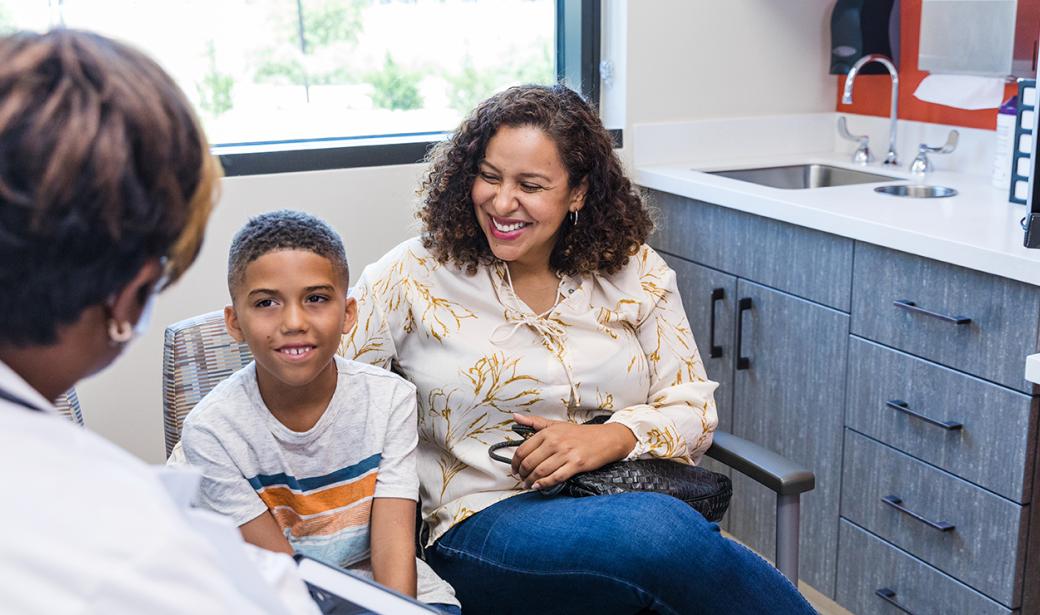 A mother and child speaking with a physician.
