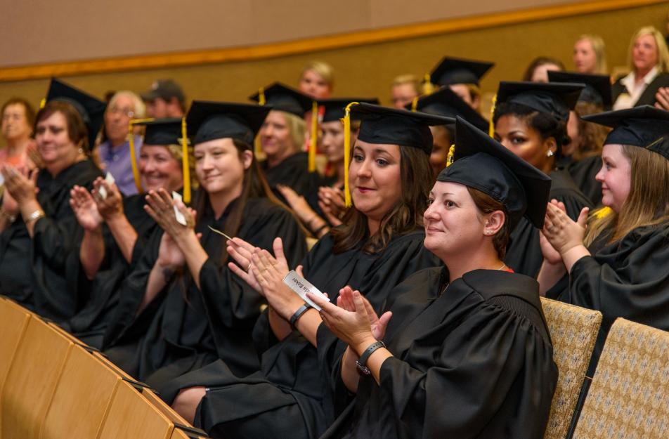 classmates at the career institute's first official cap-and-gown graduation ceremony