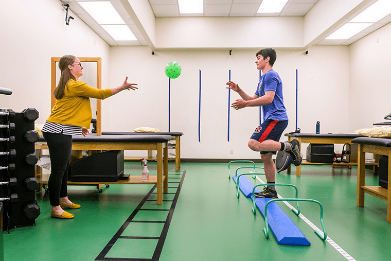 Physical therapist Mackenzie Gerau works with a patient who is recovering from a concussion.
