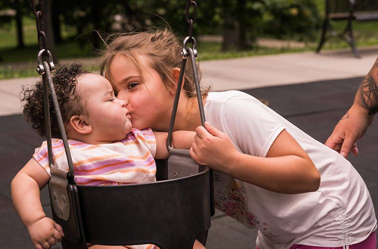Nola gets a kiss from her sister, Paisley, at Jefferson City Memorial Park