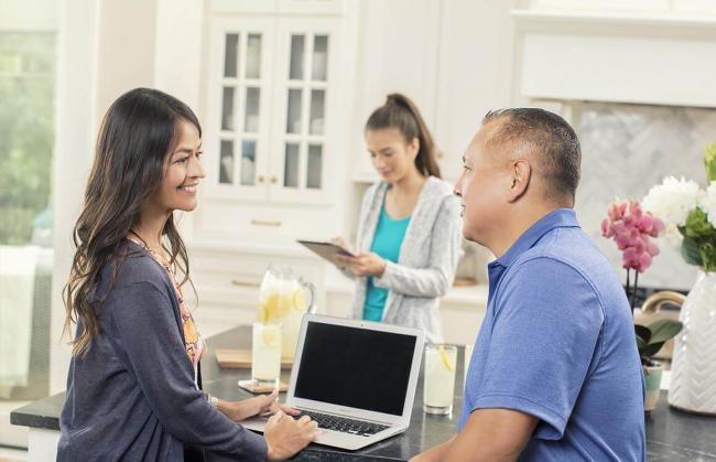 woman and man looking at laptop