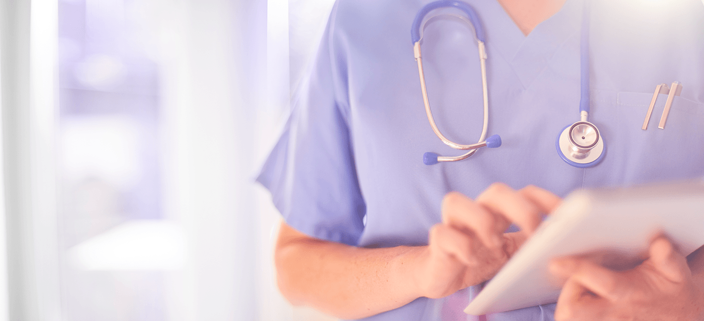 Photo of doctor holding tablet computer