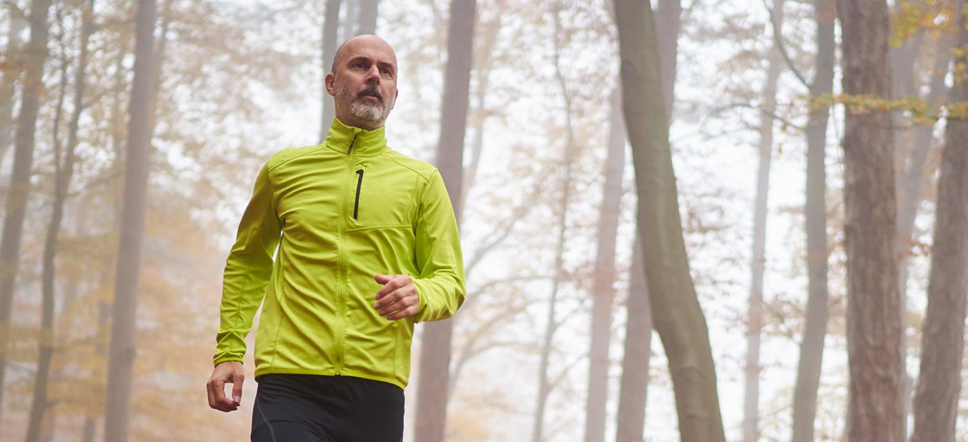 Photo of man running on a wooded trail