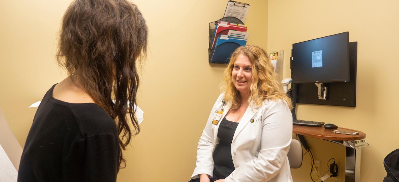 Dr. Kari Martin talking with dermatology patient