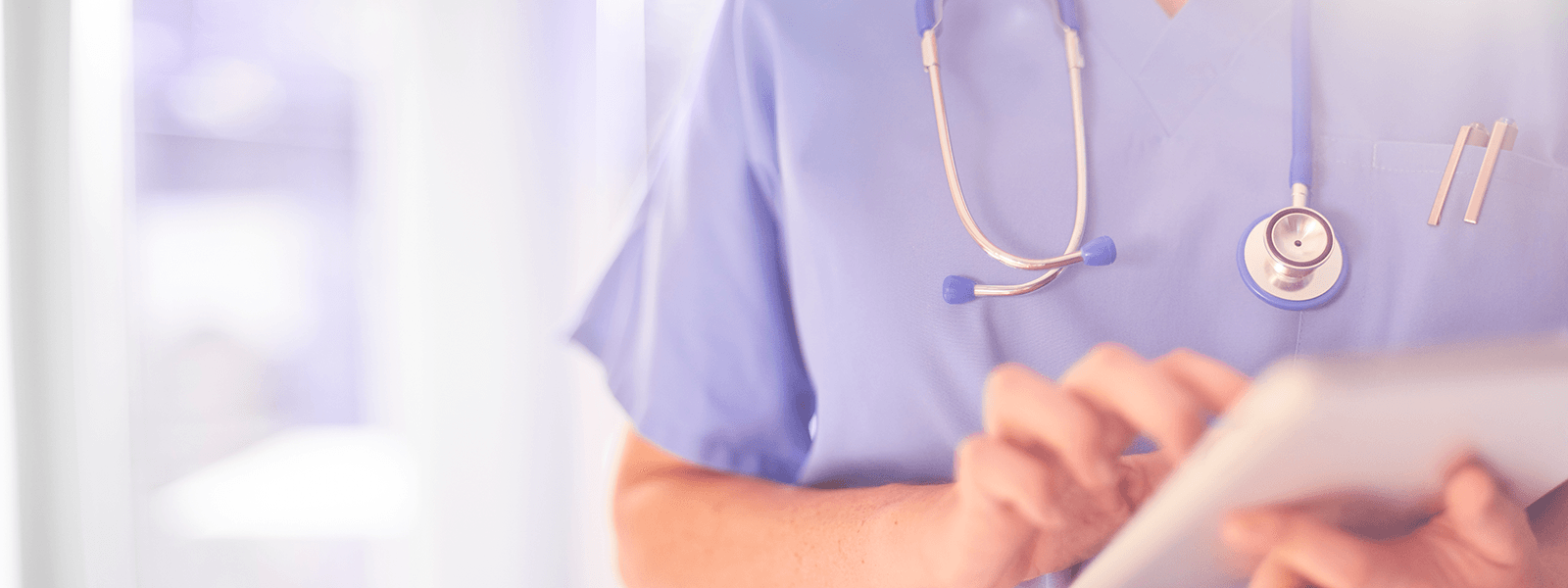 Photo of doctor holding tablet computer