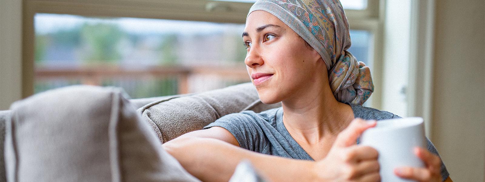 Female cancer patient sitting on a couch