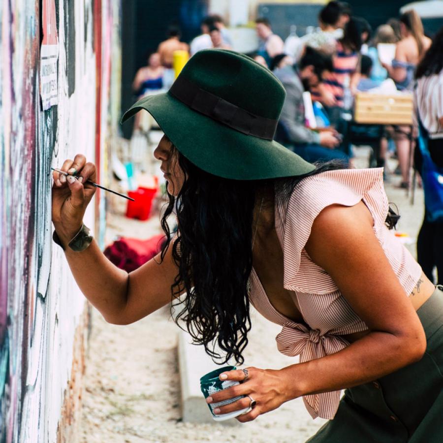 girl painting on a wall